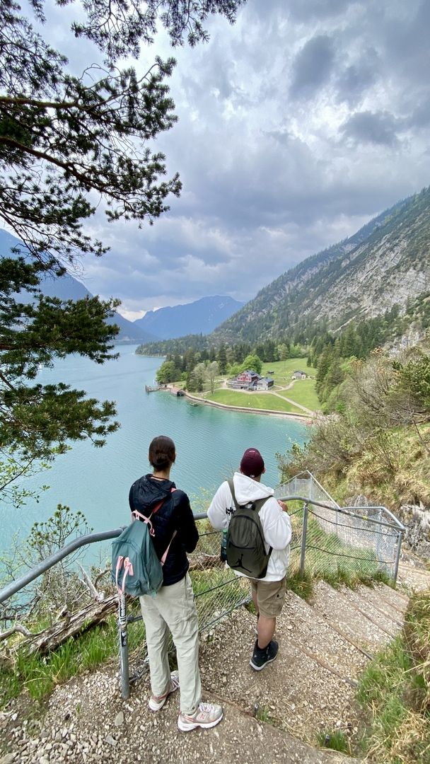 Zwei Menschen auf einer Treppe mit einem See im Hintergrund